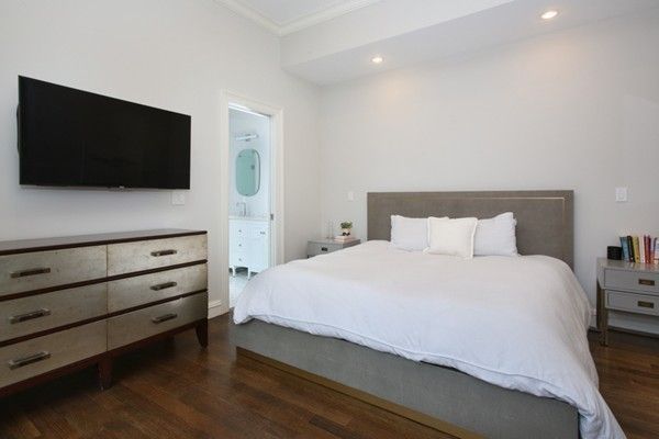 a bedroom with a bed and a flat screen tv