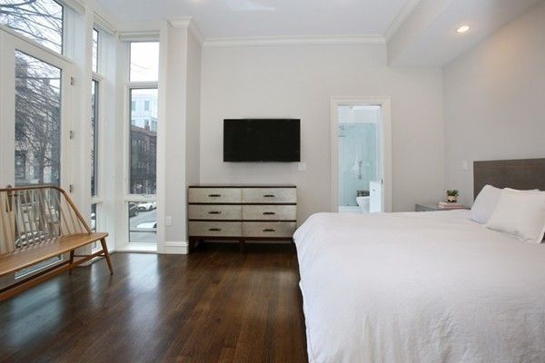 a bedroom with a bed and flat screen tv