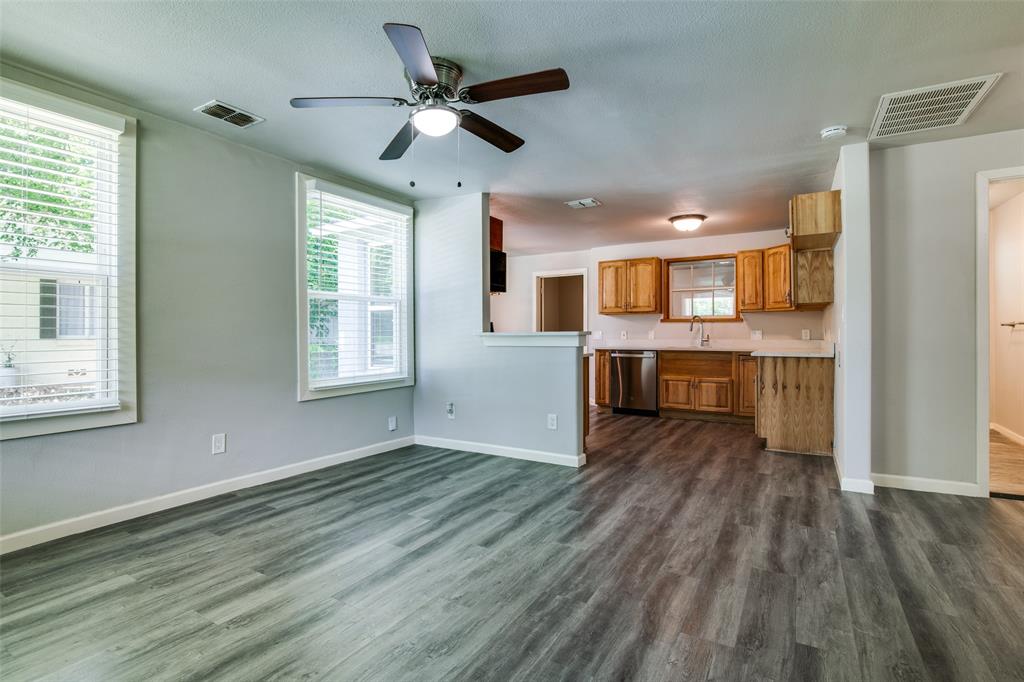 606 West High Street Terrell, TX 75160 - Photo 8 of 28 a view of a kitchen with wooden floor and a window