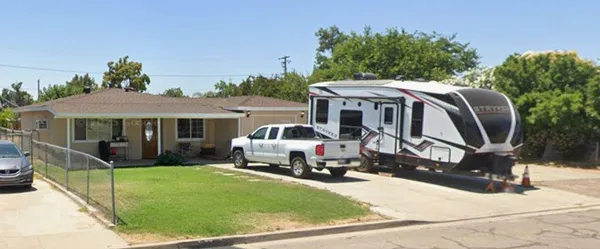 a view of a house with backyard porch and sitting area