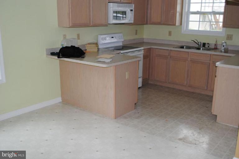 440 Ford Circle Inwood, WV 25428 - Photo 3 of 8 a kitchen with a sink cabinets and window