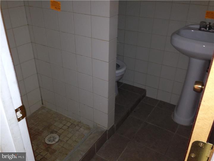 6316 Jackson Street Philadelphia, PA 19135 - Photo 12 of 14 a bathroom with a sink and shower