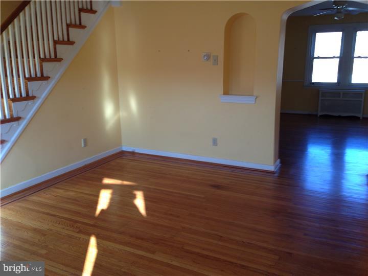 6316 Jackson Street Philadelphia, PA 19135 - Photo 3 of 14 a view of empty room with wooden floor and fan
