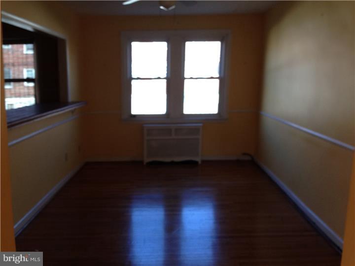 6316 Jackson Street Philadelphia, PA 19135 - Photo 4 of 14 a view of a room with wooden floors and window