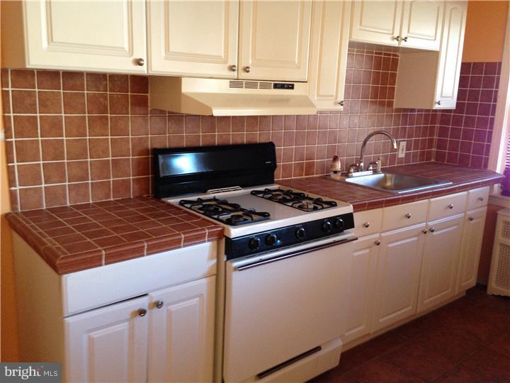 6316 Jackson Street Philadelphia, PA 19135 - Photo 5 of 14 a stove top oven sitting inside of a kitchen