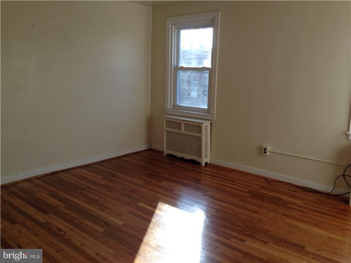 6316 Jackson Street Philadelphia, PA 19135 - Photo 6 of 14 a view of empty room with wooden floor and fan