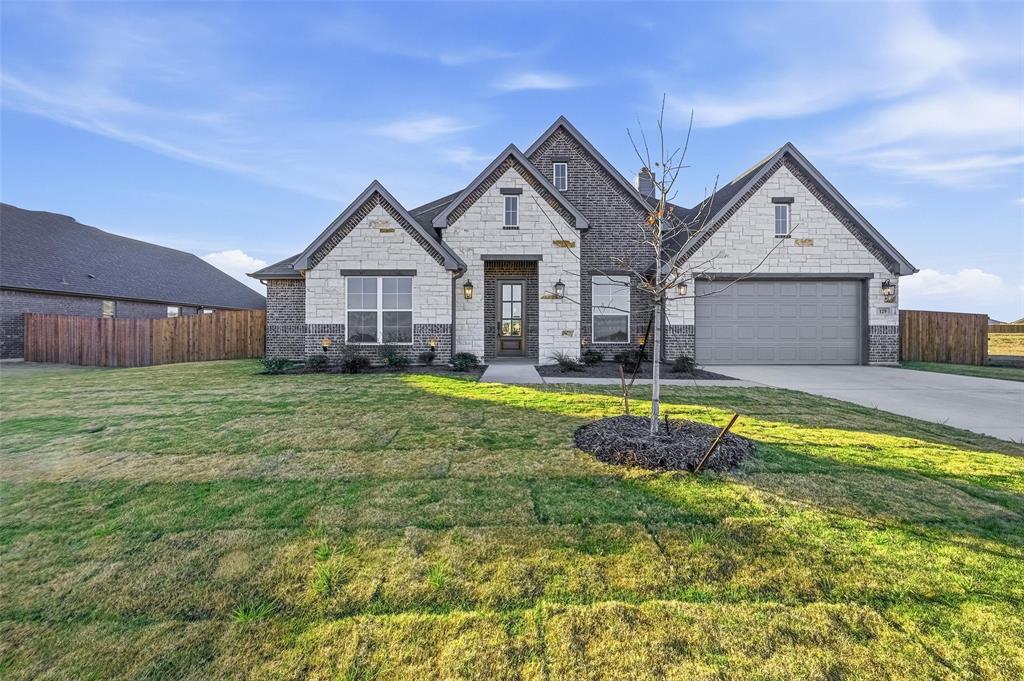 a view of a house with a big yard and large trees