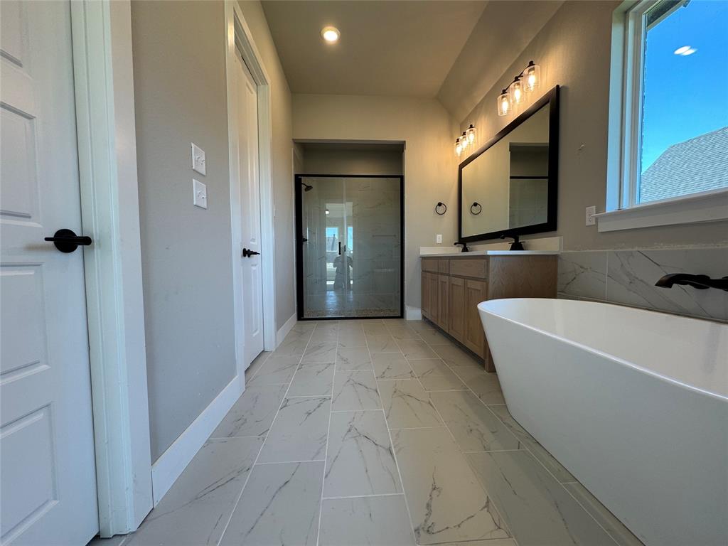 129 Mikasi Street Godley, TX 76044 - Photo 13 of 21 a bathroom with a bathtub shower sink and mirror