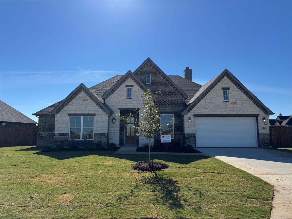 129 Mikasi Street Godley, TX 76044 - Photo 2 of 21 a front view of a house with a yard