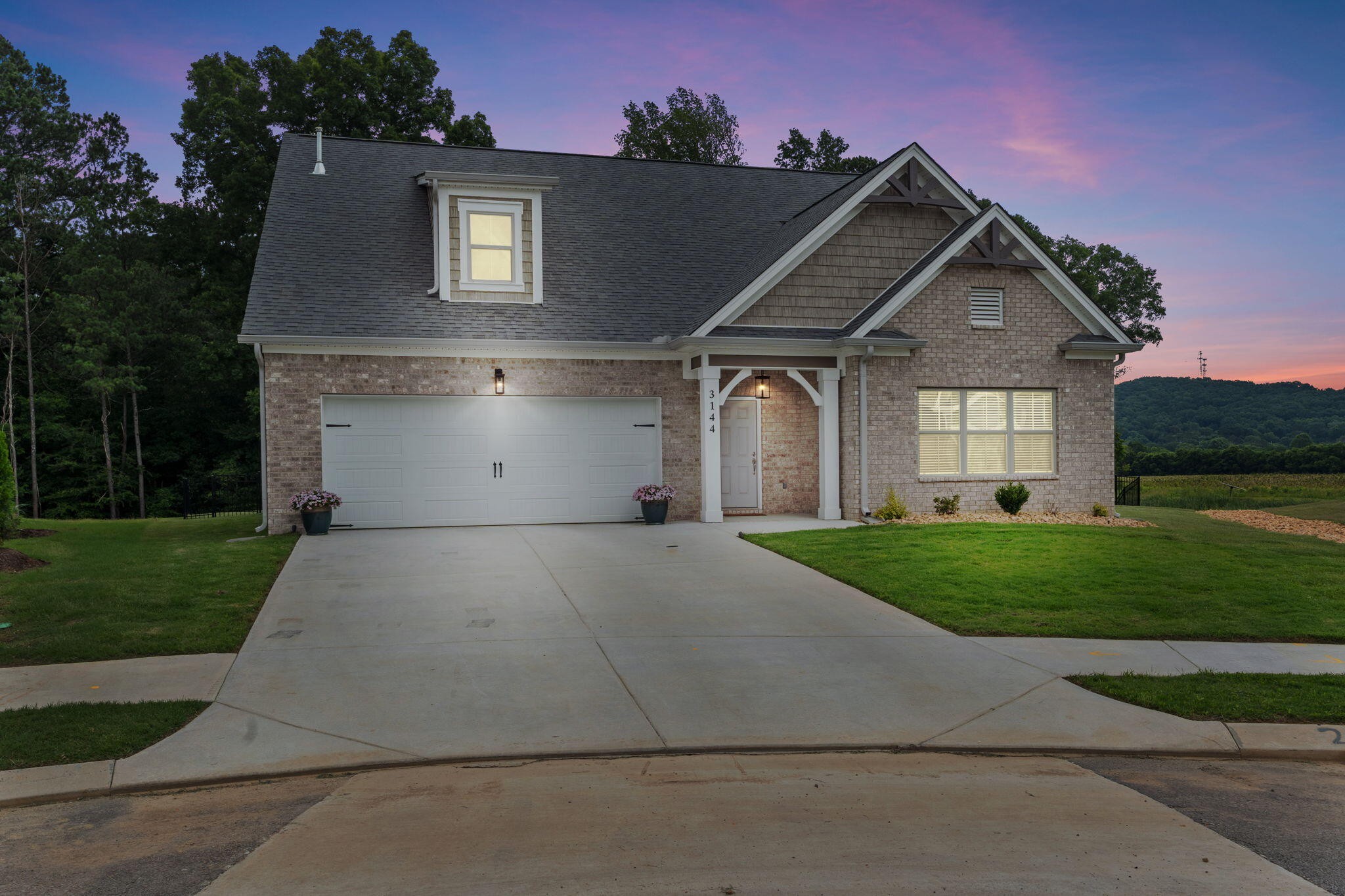 3144 Destination Trail Northwest Cleveland, TN 37312 - Photo 2 of 33 a front view of a house with a yard and garage