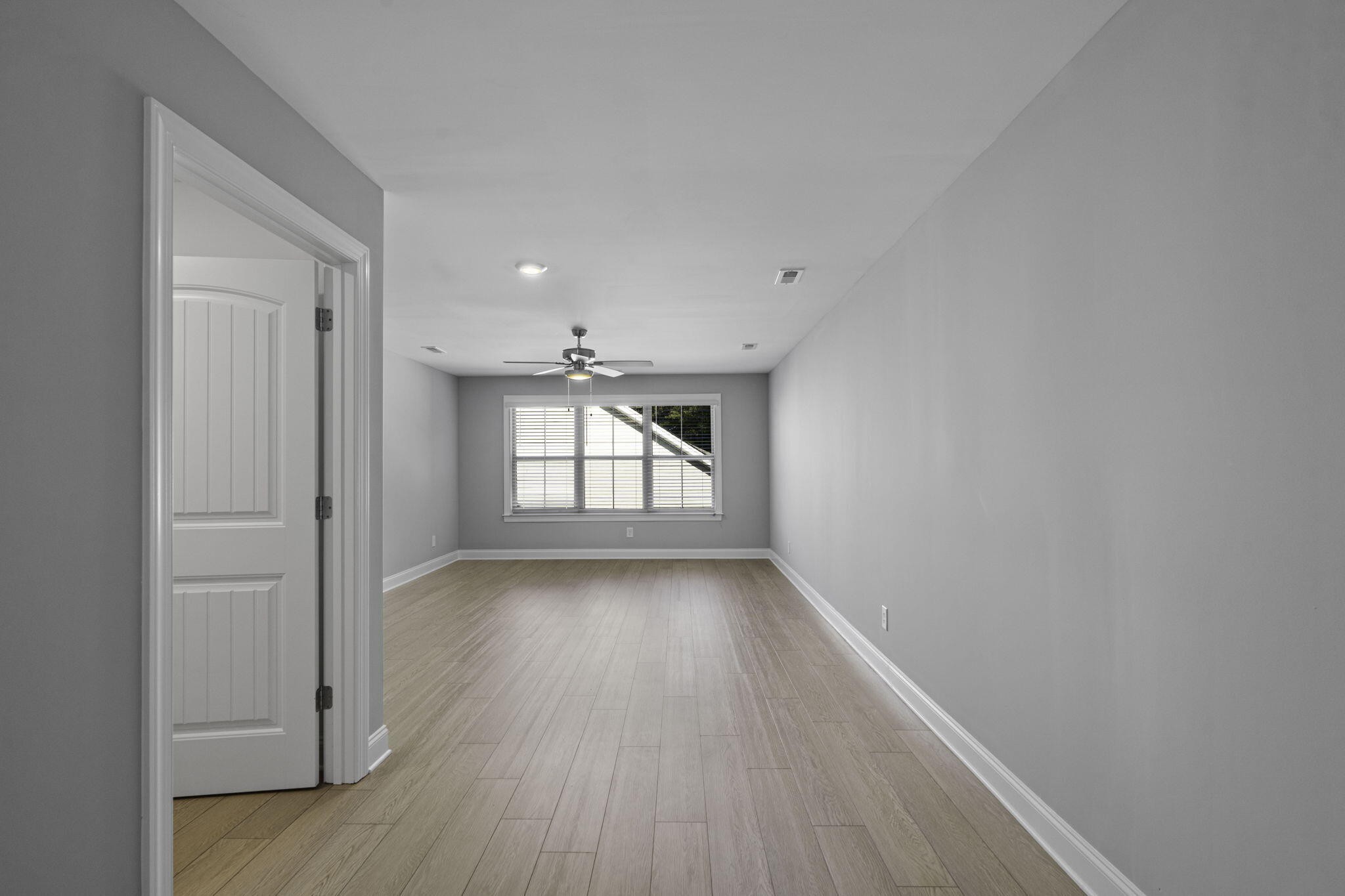 3144 Destination Trail Northwest Cleveland, TN 37312 - Photo 26 of 33 an empty room with wooden floor and windows