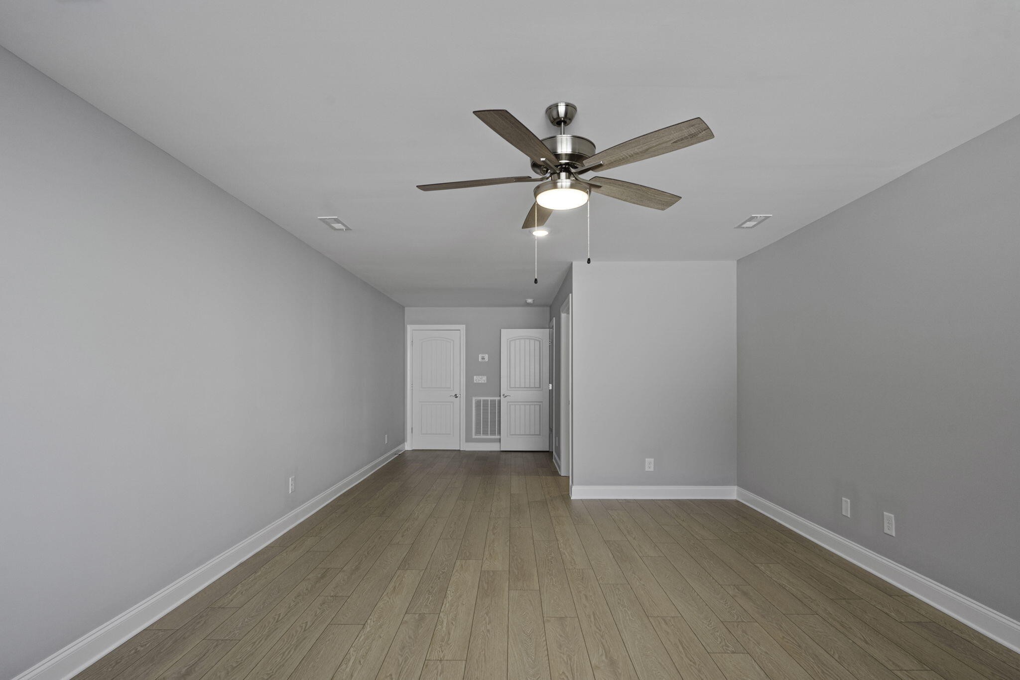 3144 Destination Trail Northwest Cleveland, TN 37312 - Photo 27 of 33 an empty room with wooden floor and a ceiling fan