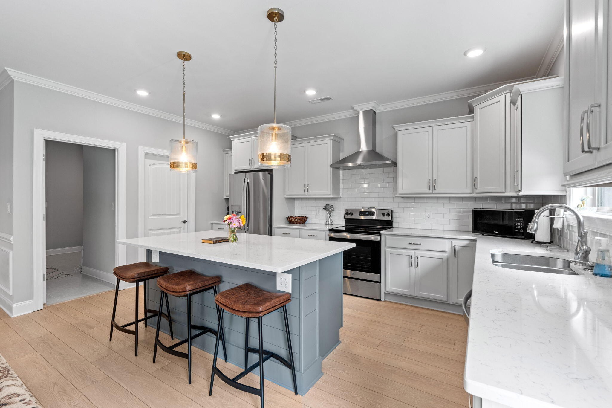 3144 Destination Trail Northwest Cleveland, TN 37312 - Photo 7 of 33 a kitchen with stainless steel appliances kitchen island granite countertop a table chairs sink and cabinets