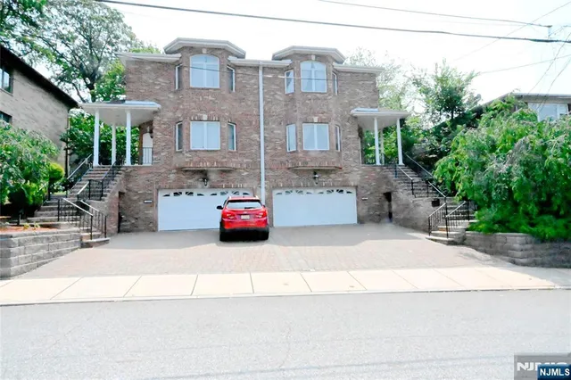 a car parked in front of a brick house