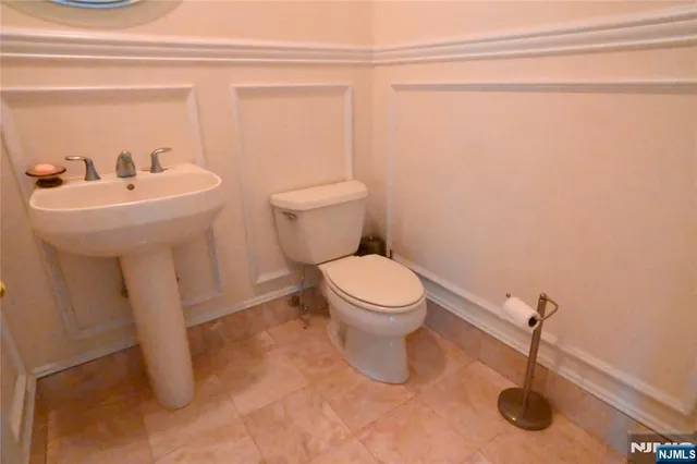 a bathroom with a sink a toilet and a shower