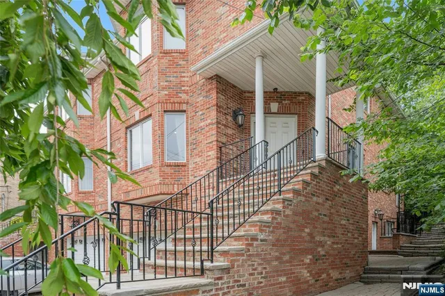 a view of a brick house with many windows