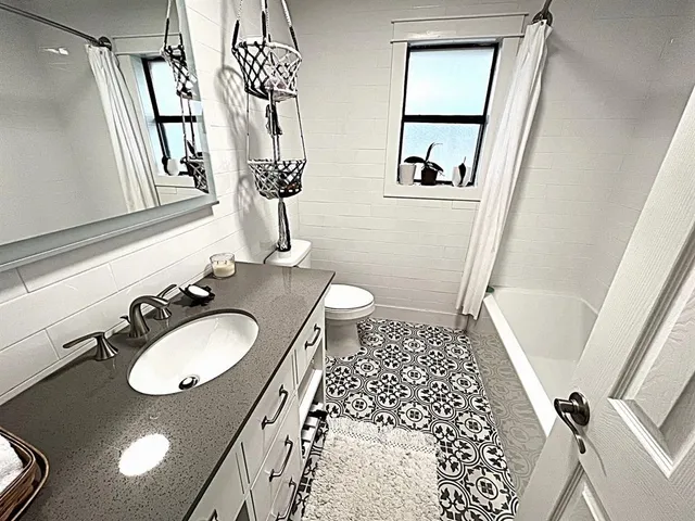 a bathroom with a double vanity sink and a mirror