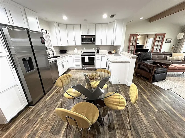 a view of a swimming pool with a patio and a yard