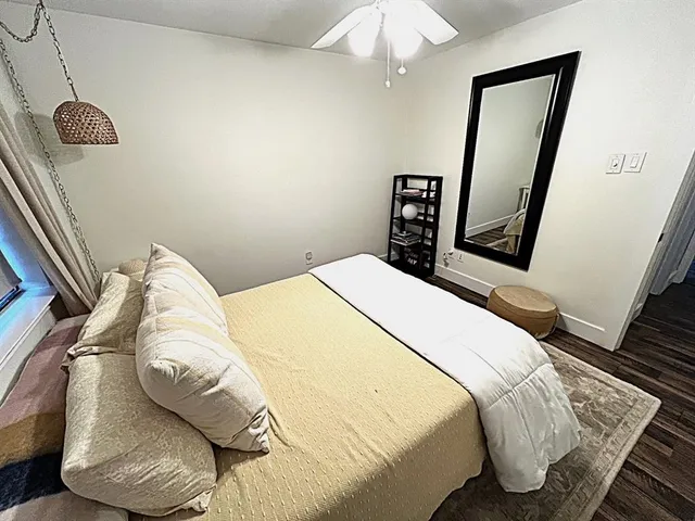 a bedroom with a bed and a mirror