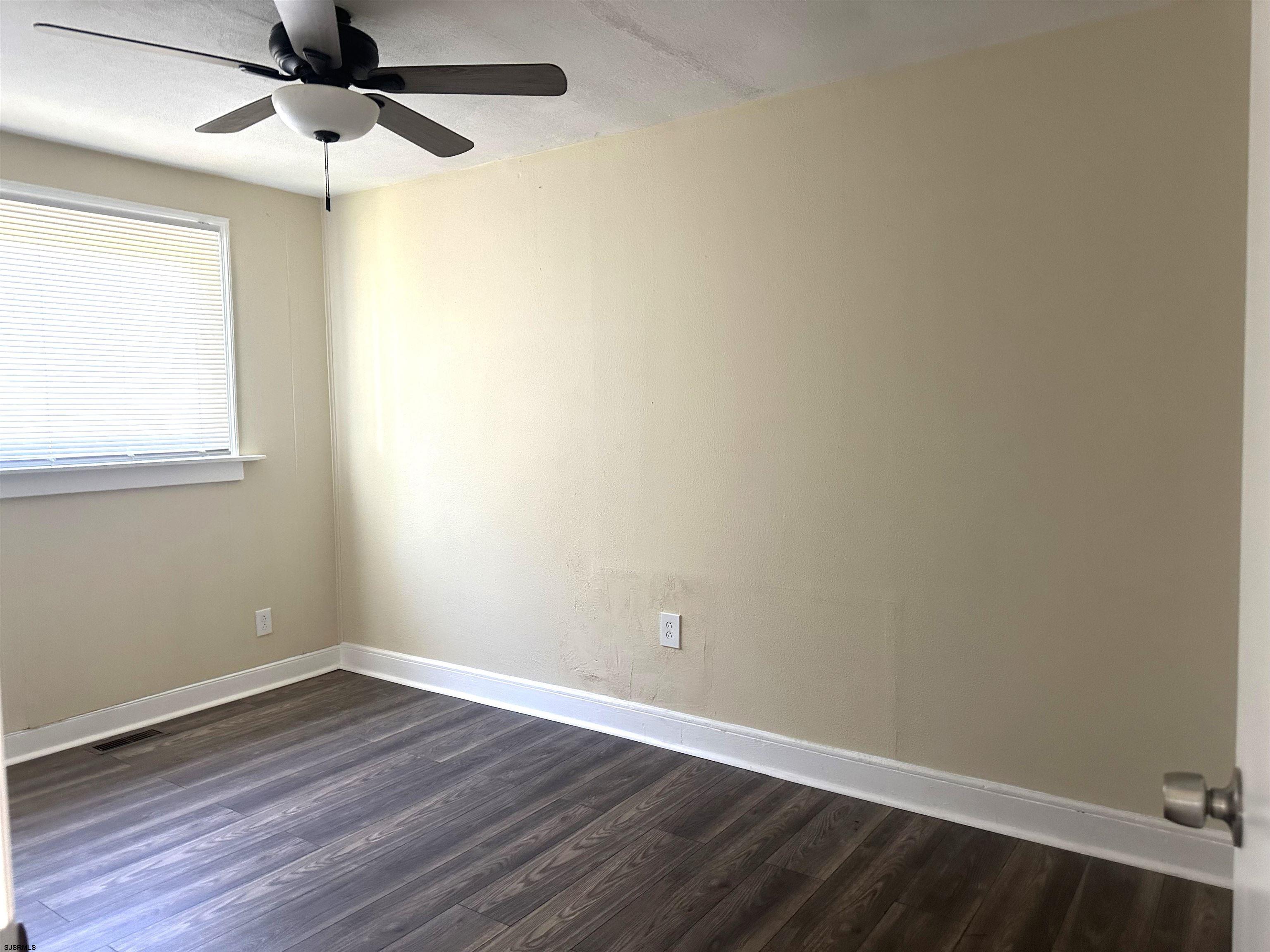 2 Creek Road Absecon, NJ 08201 - Photo 13 of 24 an empty room with a window and a ceiling fan