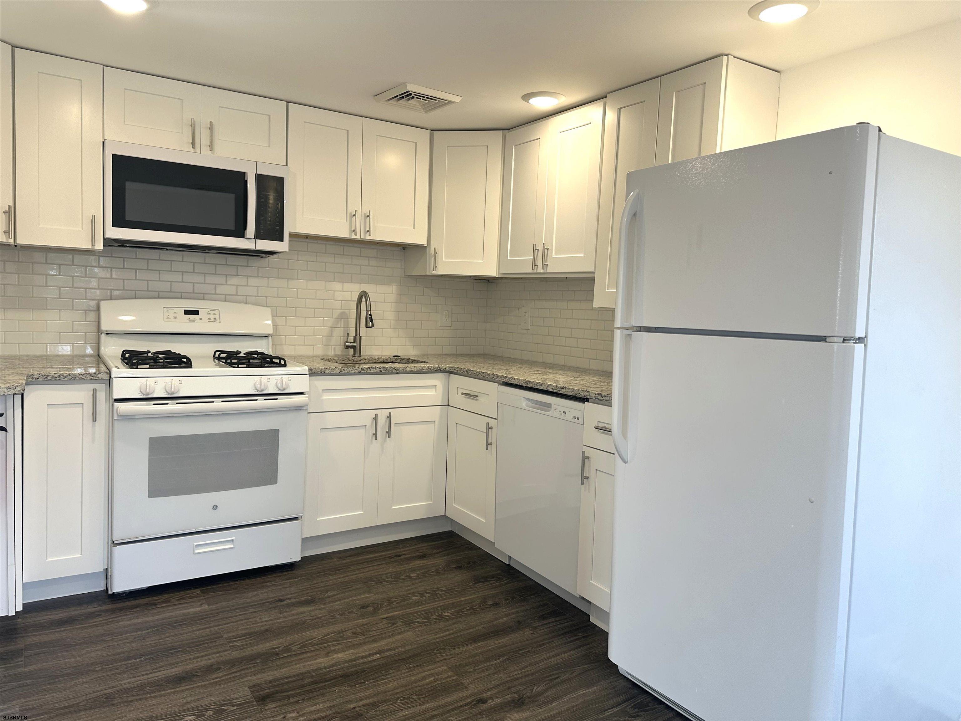 2 Creek Road Absecon, NJ 08201 - Photo 21 of 24 a kitchen with cabinets stainless steel appliances and wooden floor