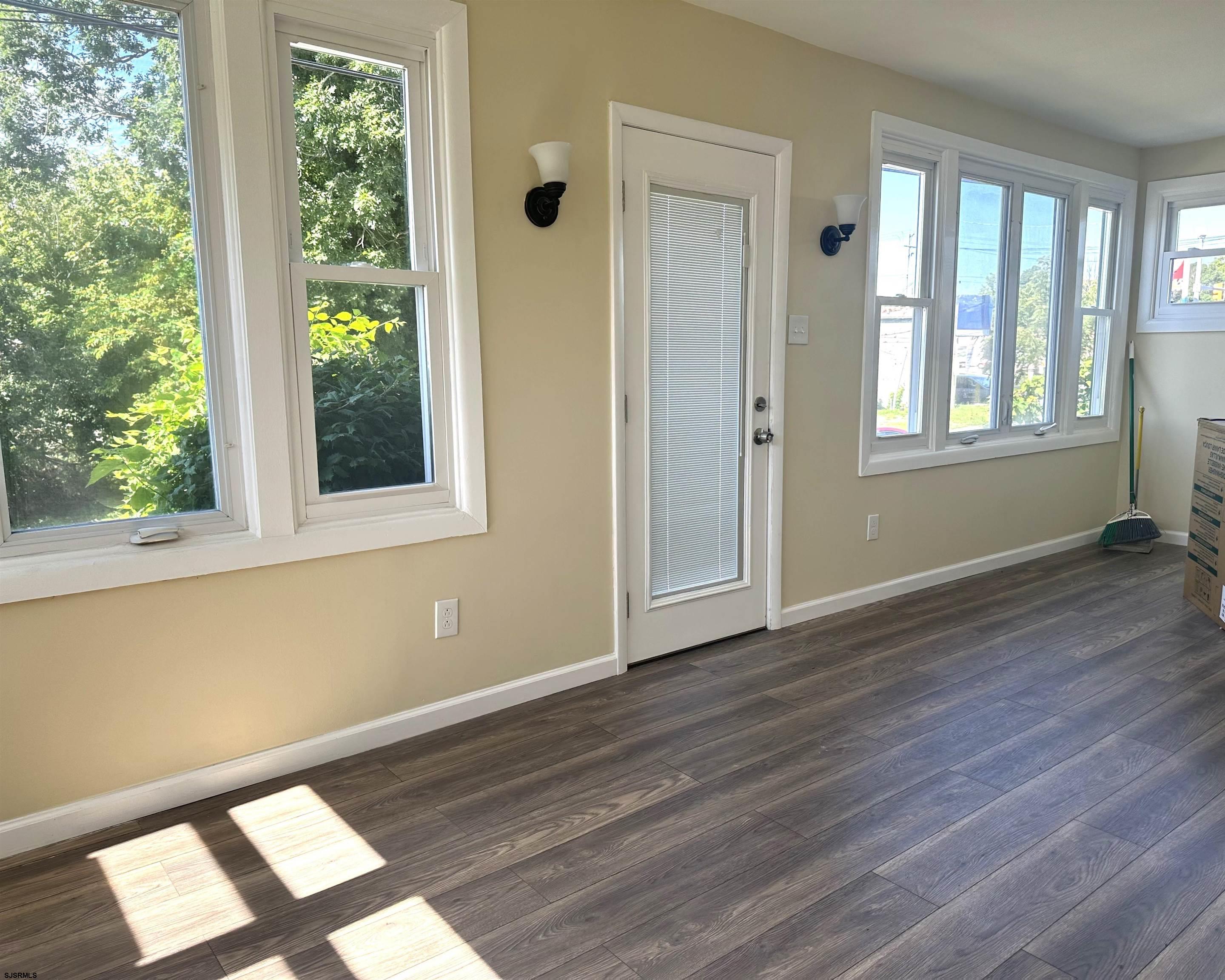 2 Creek Road Absecon, NJ 08201 - Photo 10 of 24 a view of an empty room with wooden floor and a window