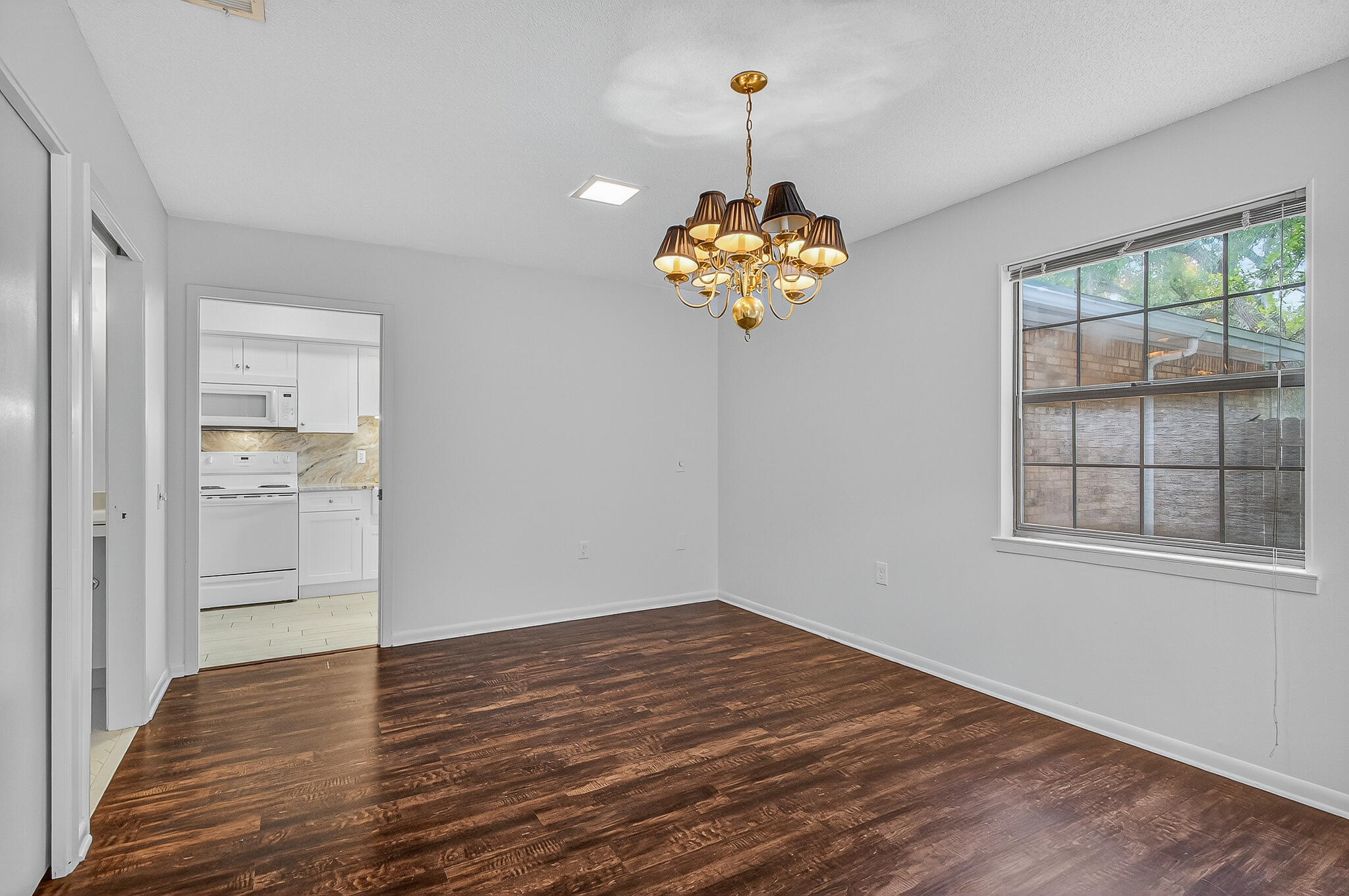 96 Yacht Club Drive, Unit 1 Fort Walton Beach, FL 32548 - Photo 12 of 43 a view of an empty room with a window and wooden floor