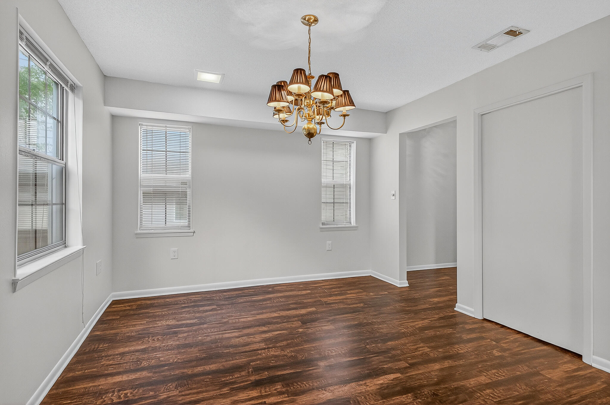 96 Yacht Club Drive, Unit 1 Fort Walton Beach, FL 32548 - Photo 13 of 43 a view of a room with wooden floor and chandelier