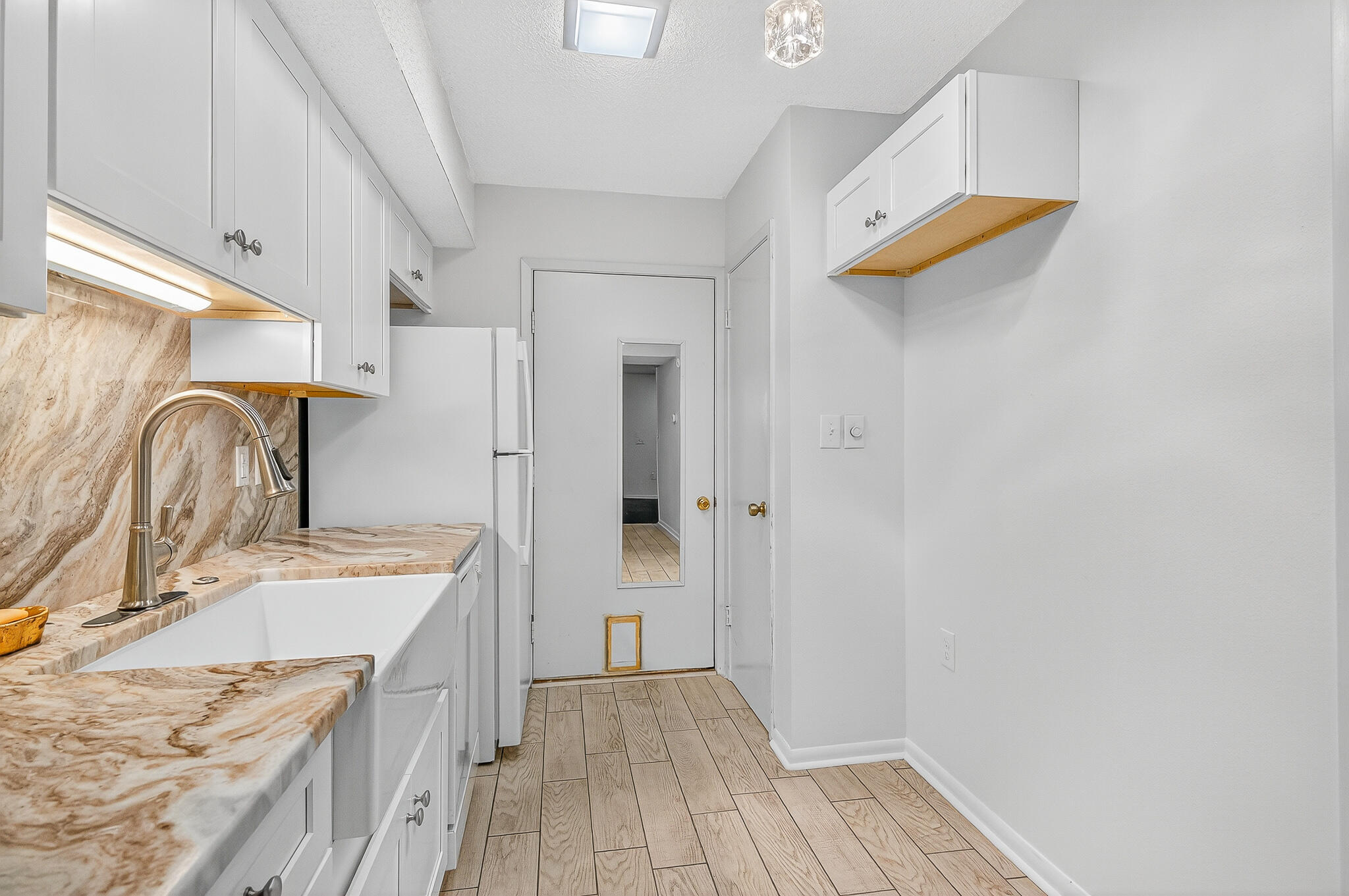 96 Yacht Club Drive, Unit 1 Fort Walton Beach, FL 32548 - Photo 19 of 43 a view of a kitchen with a sink dishwasher and wooden floor
