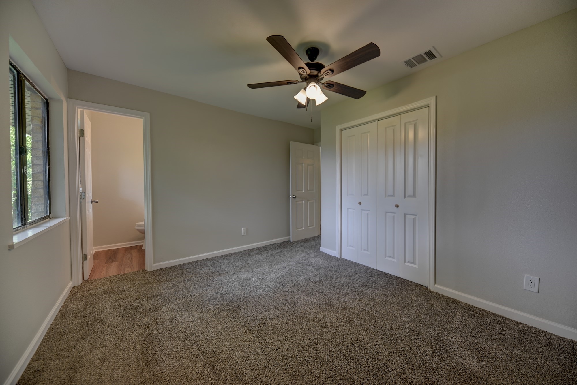 806 West Jefferson Street Brenham, TX 77833 - Photo 11 of 20 a view of a livingroom with a ceiling fan and window