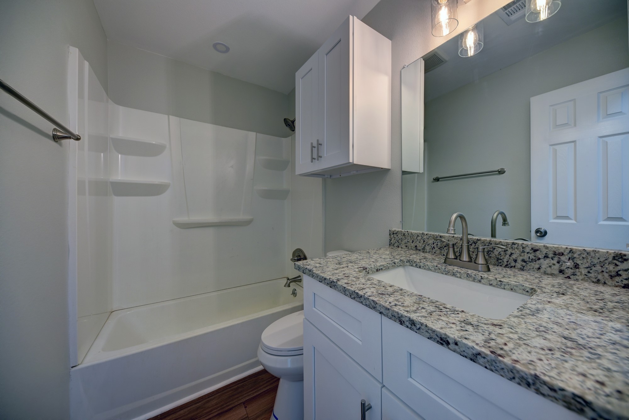 806 West Jefferson Street Brenham, TX 77833 - Photo 12 of 20 a bathroom with a granite countertop sink a toilet and bathtub