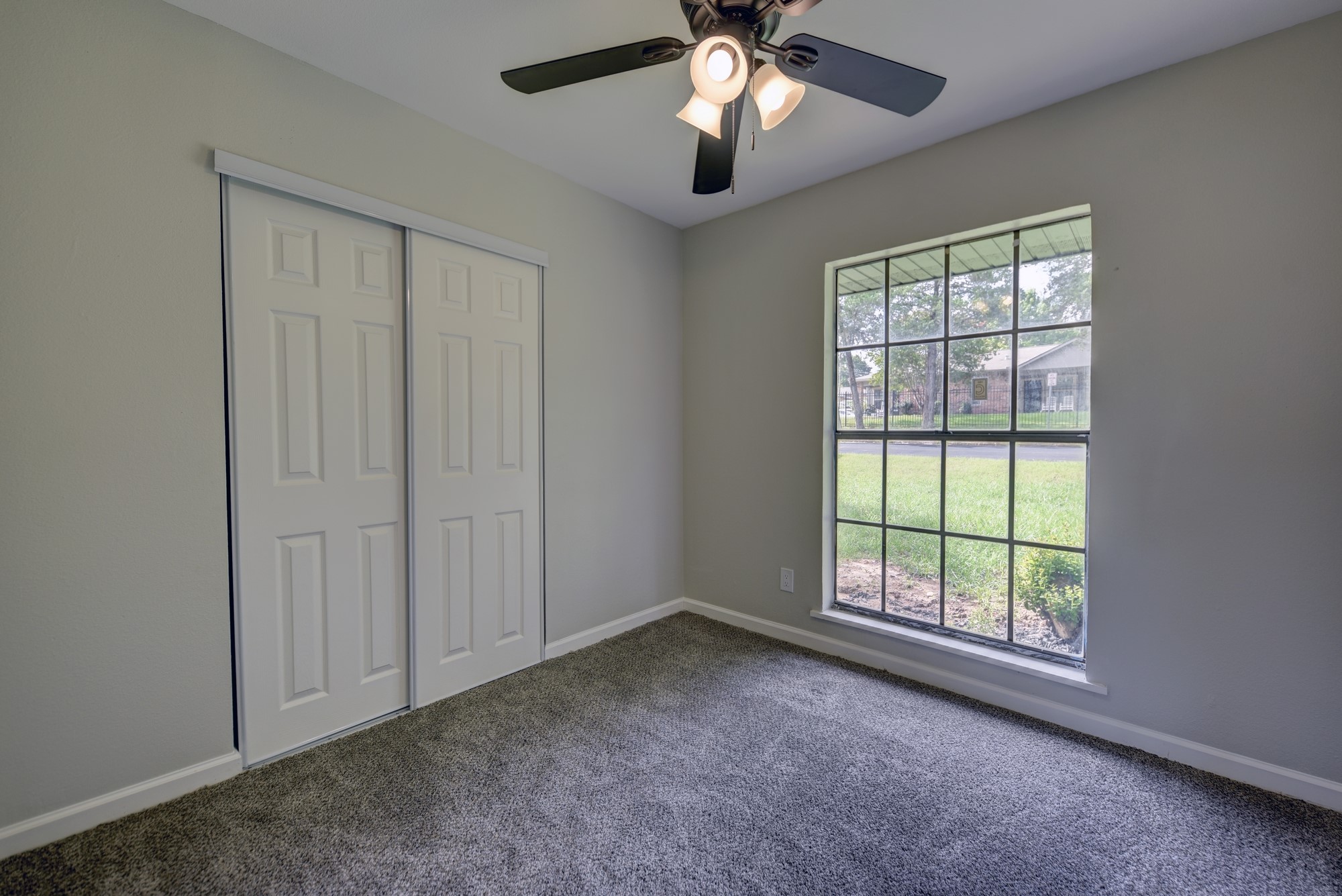 806 West Jefferson Street Brenham, TX 77833 - Photo 16 of 20 an empty room with windows and fan