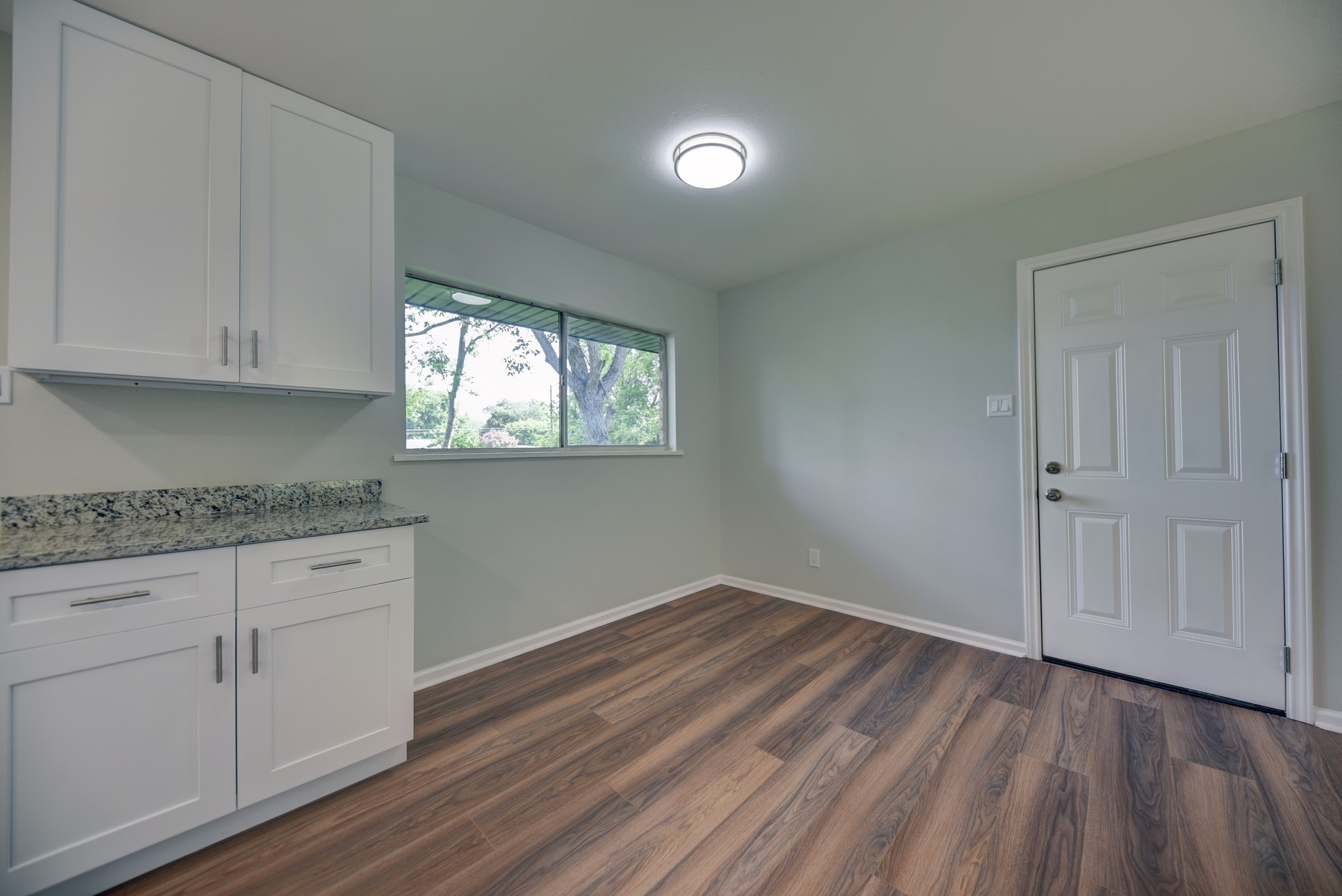 806 West Jefferson Street Brenham, TX 77833 - Photo 8 of 20 a view of kitchen with granite countertop cabinets and wooden floor