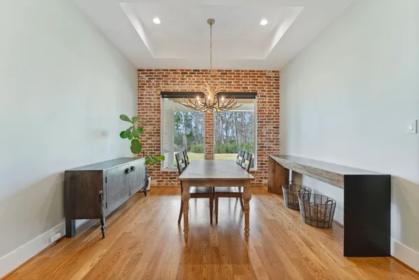 a dining room with furniture window and wooden floor