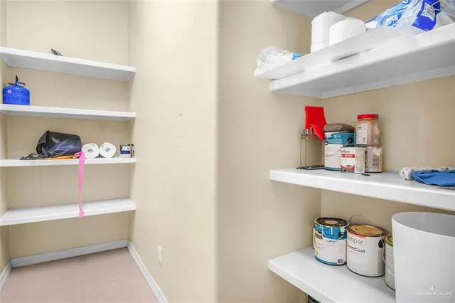 a utility room with a sink and wooden floor