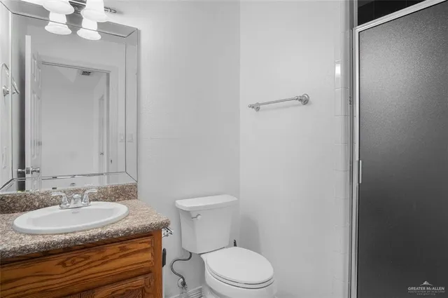a bathroom with a sink toilet a mirror and vanity
