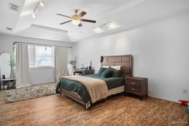 a spacious bedroom with a bed and window