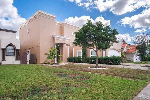 an aerial view of residential houses with outdoor space and parking
