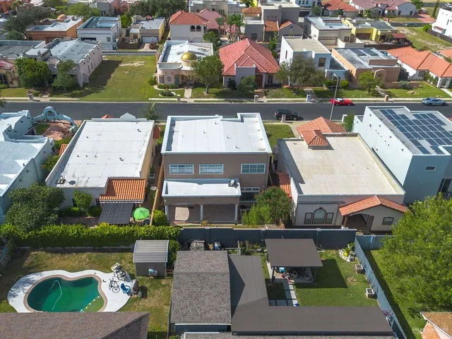 an aerial view of a residential houses with city view