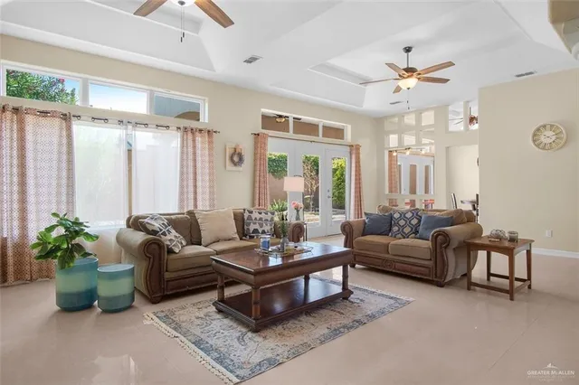 a living room with furniture ceiling fan and a window