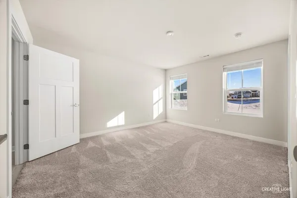 an empty room with closet and a bathroom
