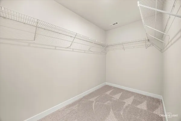a bathroom with a granite countertop sink a toilet a mirror and shower