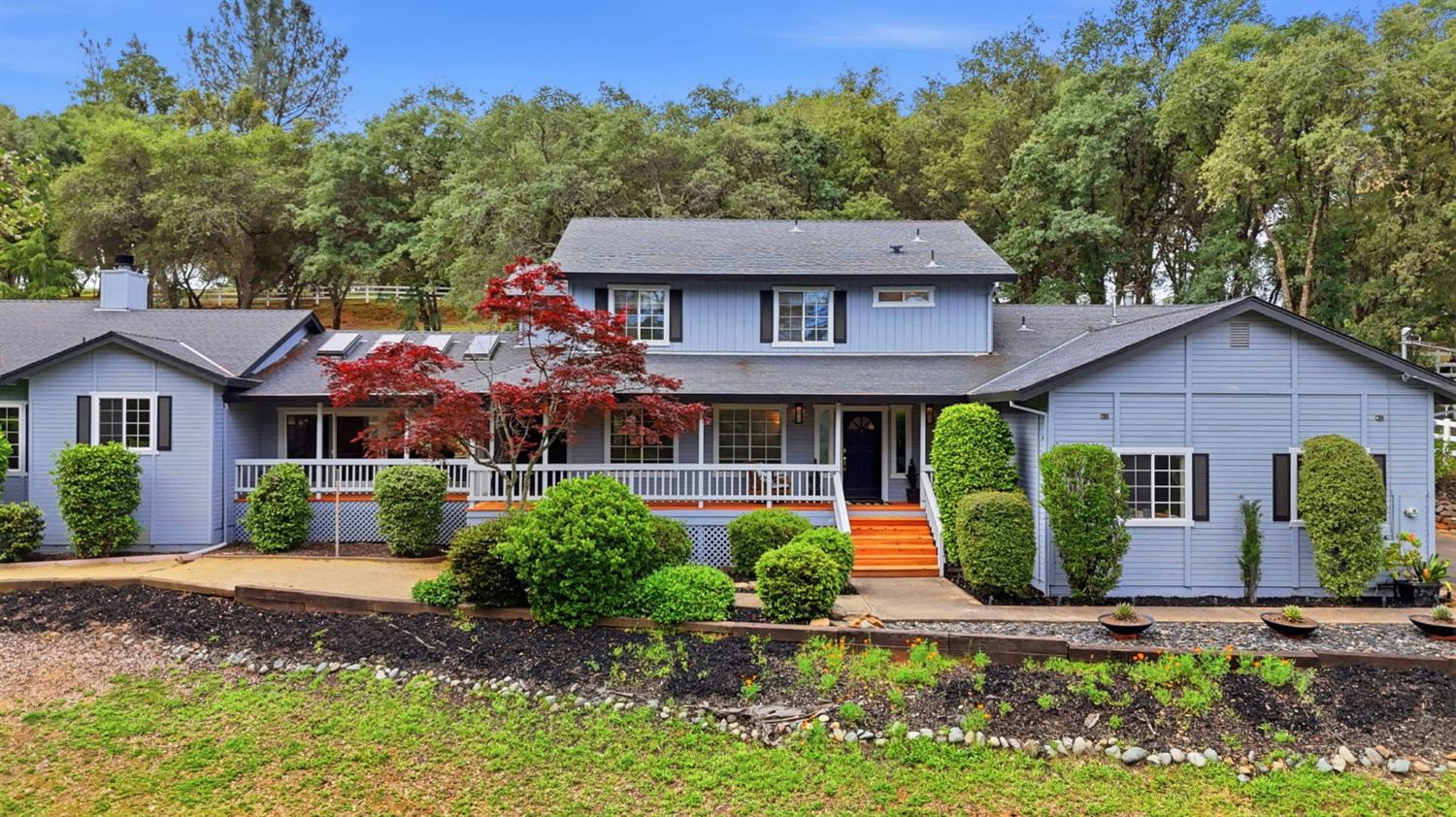 a front view of a house with garden