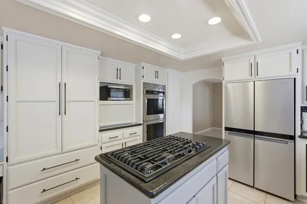 a kitchen with stainless steel appliances granite countertop a refrigerator and a sink