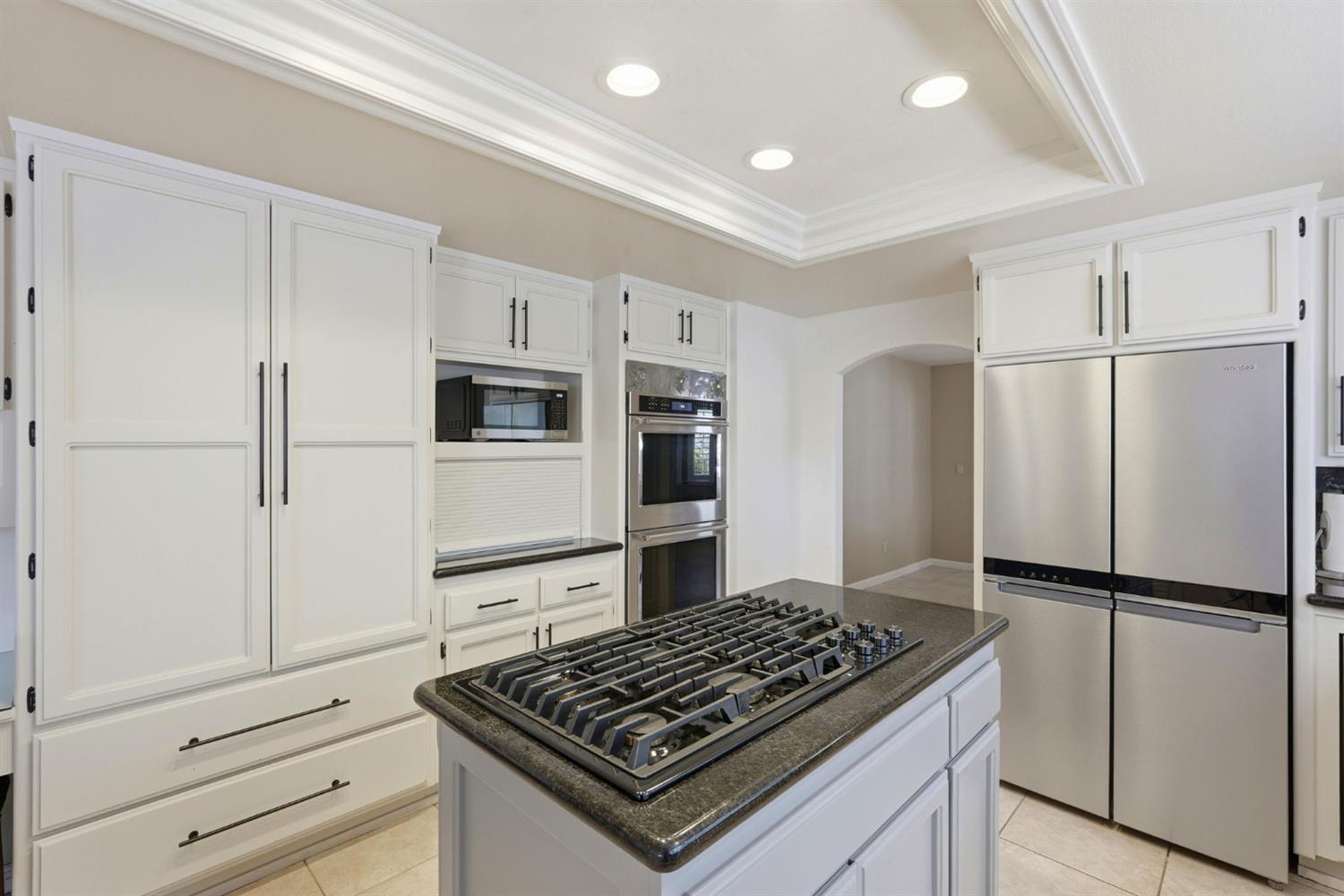 2030 Marden Drive Rescue, CA 95672 - Photo 21 of 96 a kitchen with stainless steel appliances granite countertop a refrigerator stove and white cabinets