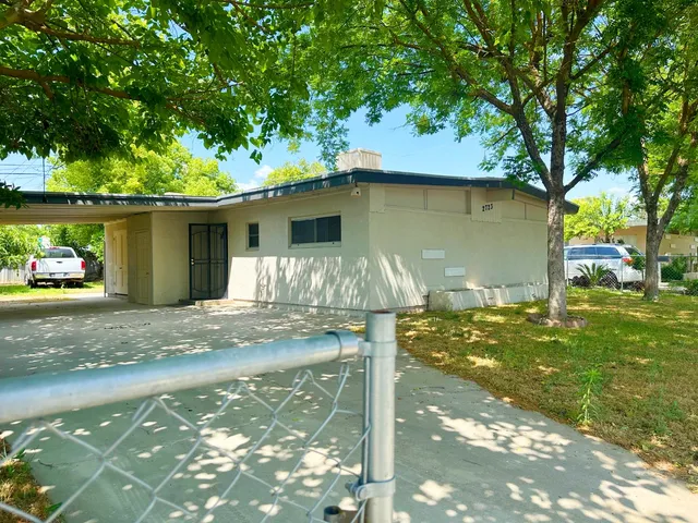 a view of a wooden house with a yard