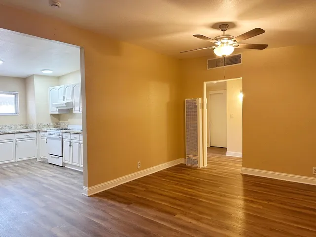 a view of a kitchen with wooden floor and a kitchen