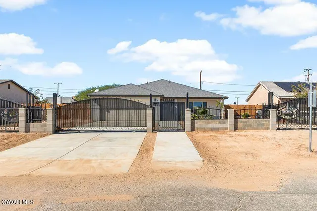 a view of house with yard and staircase