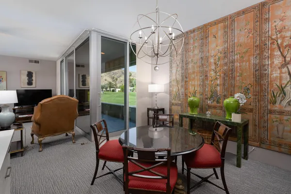 a very nice looking dining room with a table chairs and a chandelier
