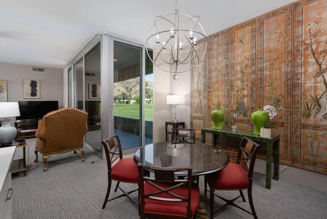 a very nice looking dining room with a table chairs and a chandelier